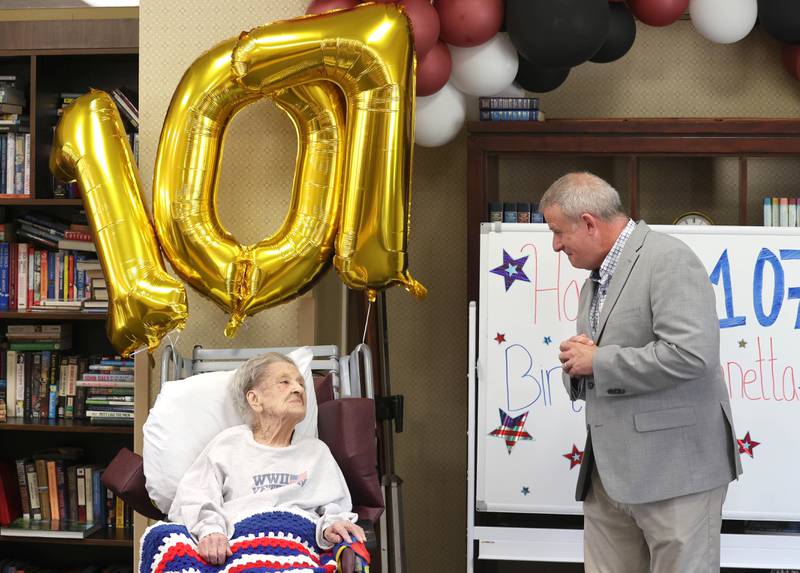 DeKalb Mayor Cohen Barnes greets World War II veteran Myrtle Annetta Lusiak Thursday, May 2, 2024, during her birthday celebration at Aperion Care in DeKalb. Lusiak, who turned 107-years-old, was honored by DeKalb officials, veterans and other local groups Thursday for her service in the Women’s Army Corps from Aug. 5, 1943 until her honorable discharge on Nov. 27, 1945.