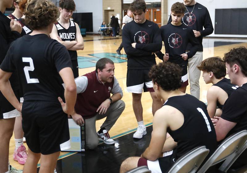Prairie Ridge Head Coach Brian Frericks talks to his team during a timeout during the 2025 Hoops for Healing tournament basketball game against Grayslake North on Wednesday, Nov. 26, 2025, at Woodstock North High School.