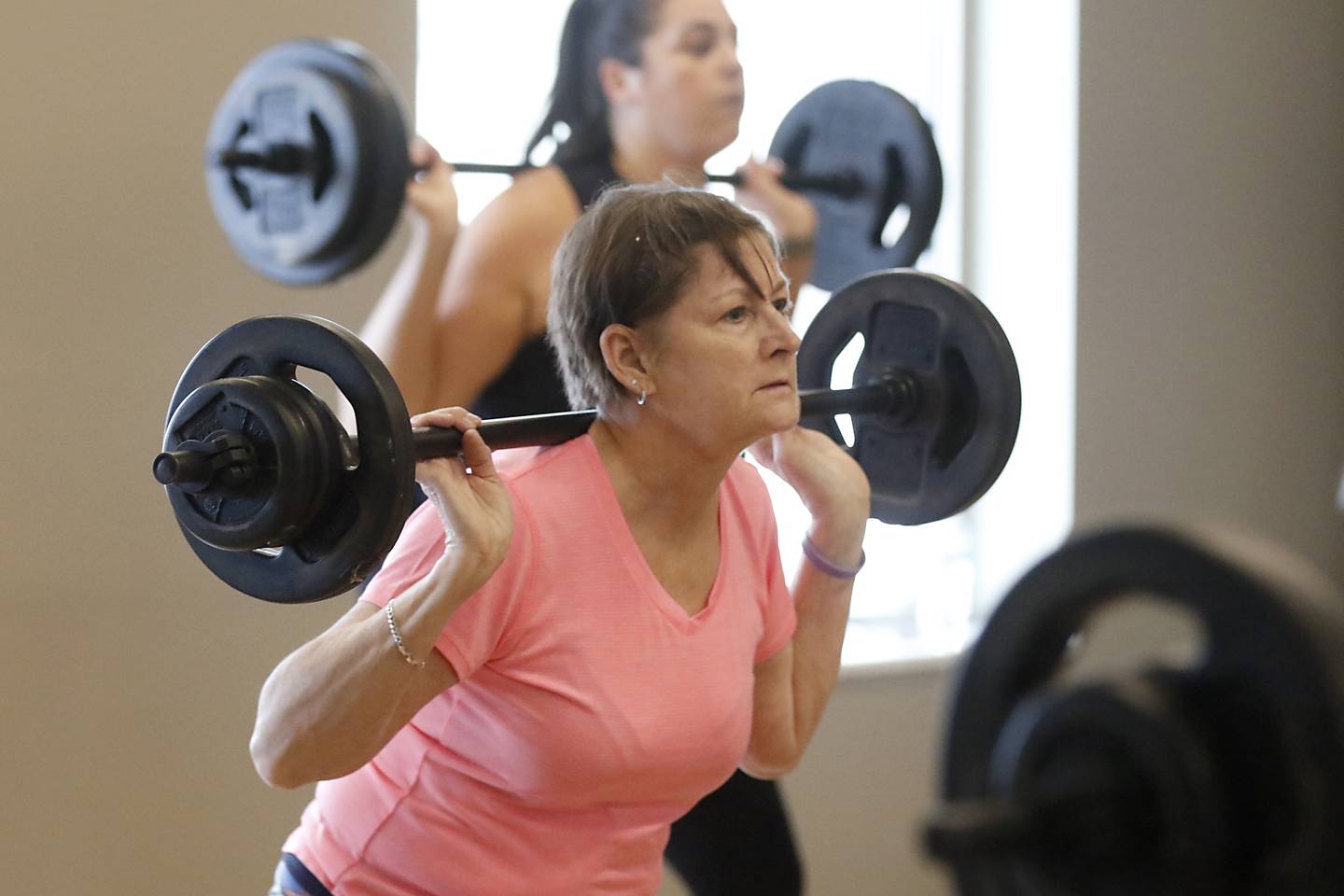 Kathy Schmidt, of McHenry, takes part in a Les Mills Body Pump and Core class Thursday, Dec. 22, 2022, at tat the McHenry Recreation Center.