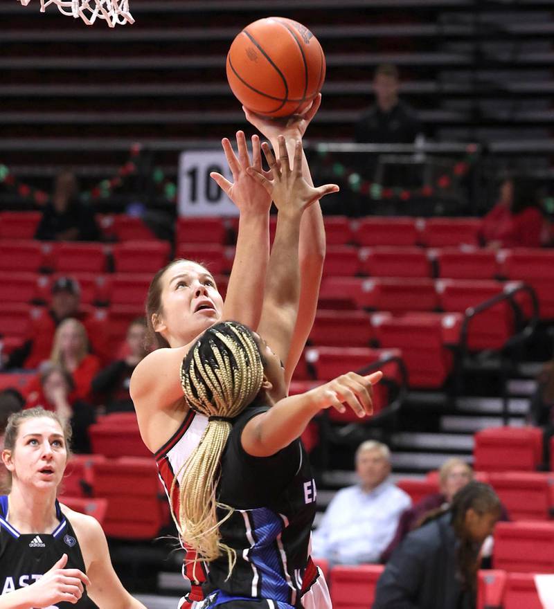 Northern Illinois' Brooke Stonebraker scores over Eastern Illinois' Charita Lewis during their game Monday, Dec. 18, 2023, at the Convocation Center at NIU in DeKalb.