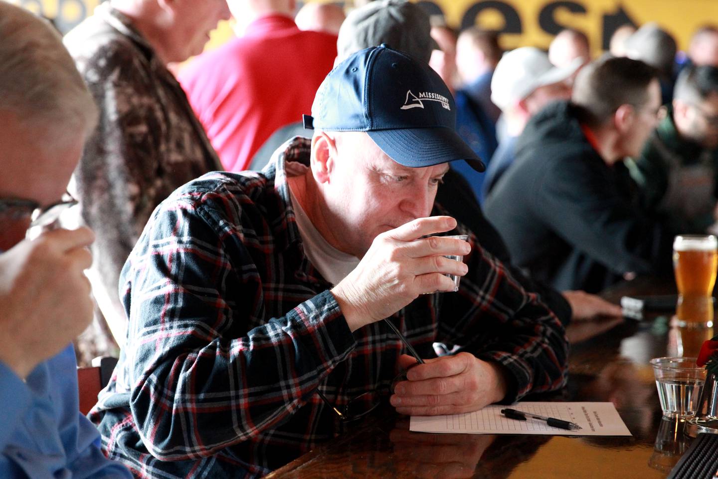 Chris Olson of Aurora tastes water in a blind taste test on Thursday, Dec. 19, 2024 during the annual Kane County Water Association's annual water tasting contest at Global Brew in St. Charles.