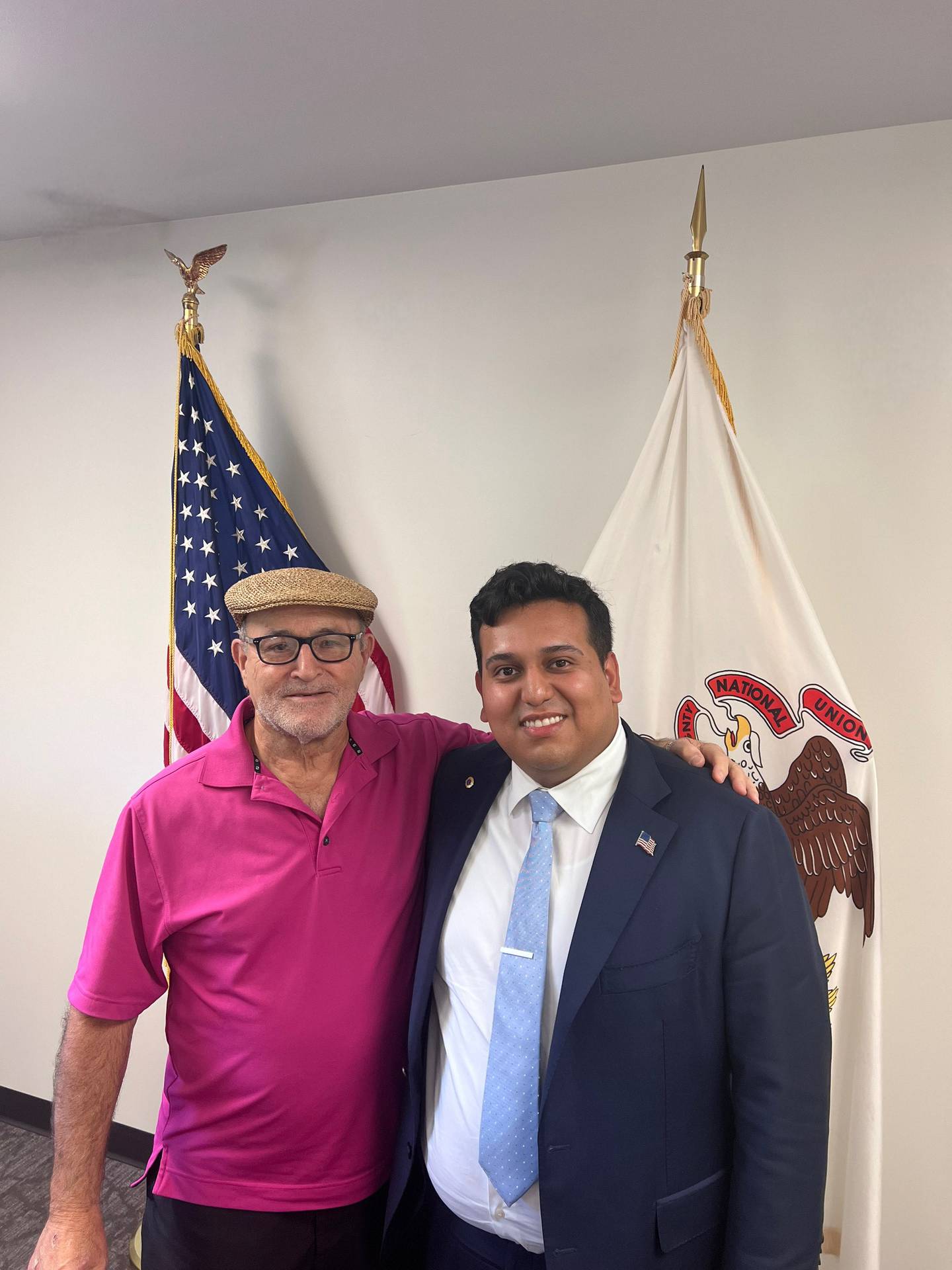 Former Lockport Township Clerk George Mushro and Lockport Township Supervisor Alex Zapien embrace at an August 2023 meeting.