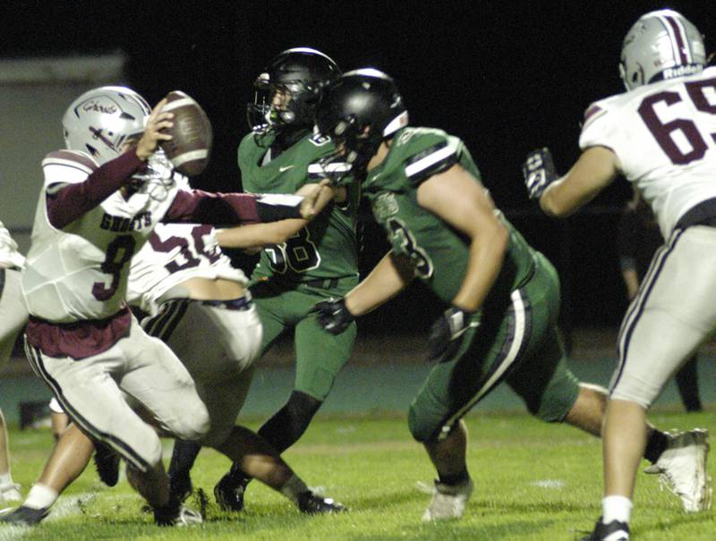 IVC QB Keegan Schoi is brought down by Rocket defenders. The Grey Ghosts of Illinois Valley Central traveled to Hinders Field in Rock Falls on Friday, October 10, 2025 to take on the Rockets.