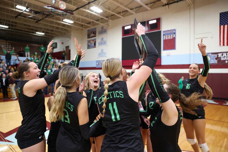 Providence players rejoice as they hoist the IHSA Class 3A Kankakee Sectional championship following the Celtics' victory in two sets, 25-25, 25-18, over Lemont in the on Thursday, Nov. 6, 2025.