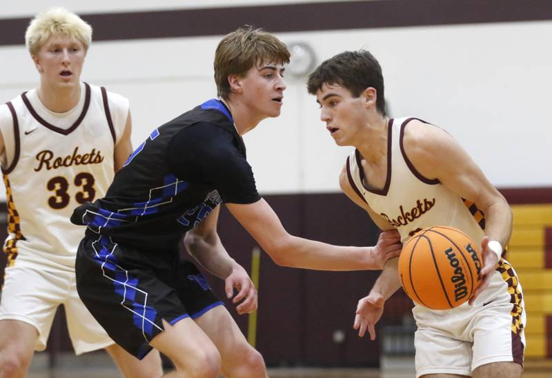 Richmond-Burton's Dane Gardner (right) drives the baseline against Woodstock's Liam Laidig during a Kishwaukee River Conference boys basketball game on Friay Jan. 9  2026, at Richmond-Burton High School, in Richmond.