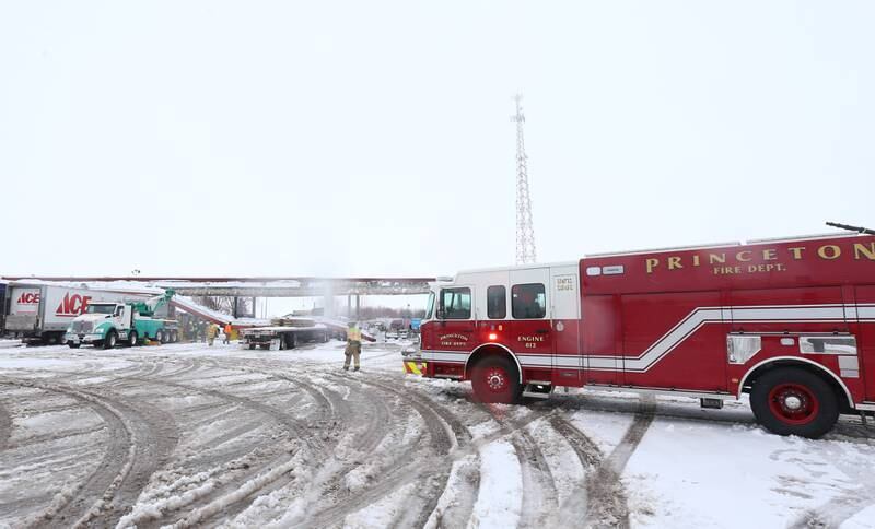 Princeton firefighters arrive to the scene to assist with debris that fell from the canopy over the gasoline pumps after being struck by an Ace Hardware semi truck on Friday, Jan. 12, 2024 in Princeton.