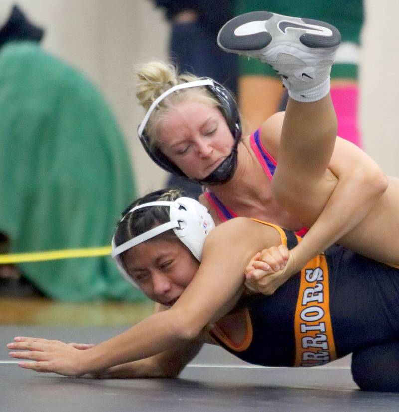 McHenry’s Alexa Colin-Garcia, bottom, battles Belvidere North’s Lilian Davis at 110 pounds in Whip-Pur Women’s Classic varsity girls wrestling on Saturday, Dec. 20, 2025, at Hampshire High School in Hampshire.