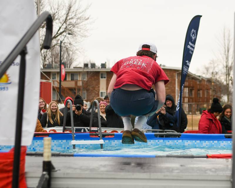 Taylor Wessong of Downers Grove, who was the last participant of the Polar Plunge cannonballs into the pool on Saturday Feb. 21, 2026, held at Huskie Stadium in DeKalb.