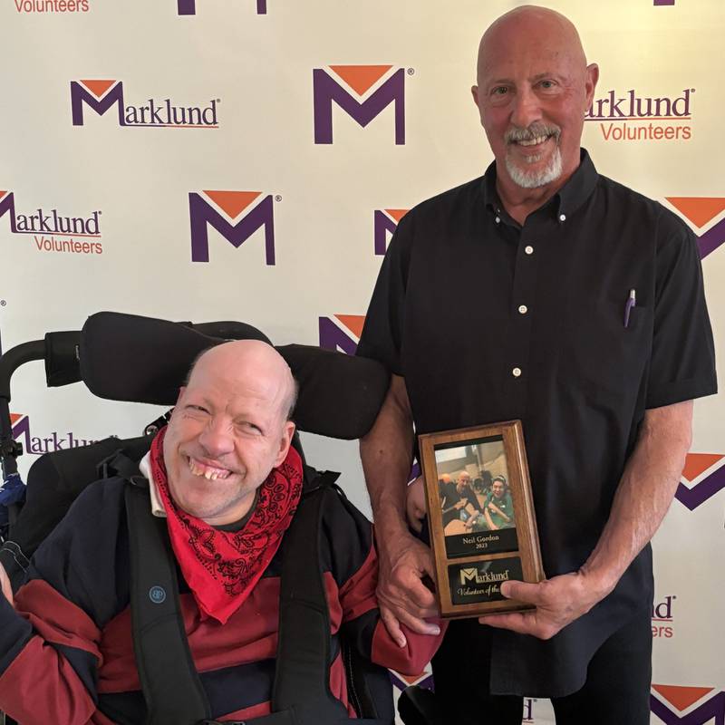 Marklund resident Jimmy (left) helps present the 2023 Volunteer of the Year award to Neil Gordon of Elburn at the Volunteer Appreciation Brunch on April 27, 2024, at St. Andrews Golf and Country Club in West Chicago.