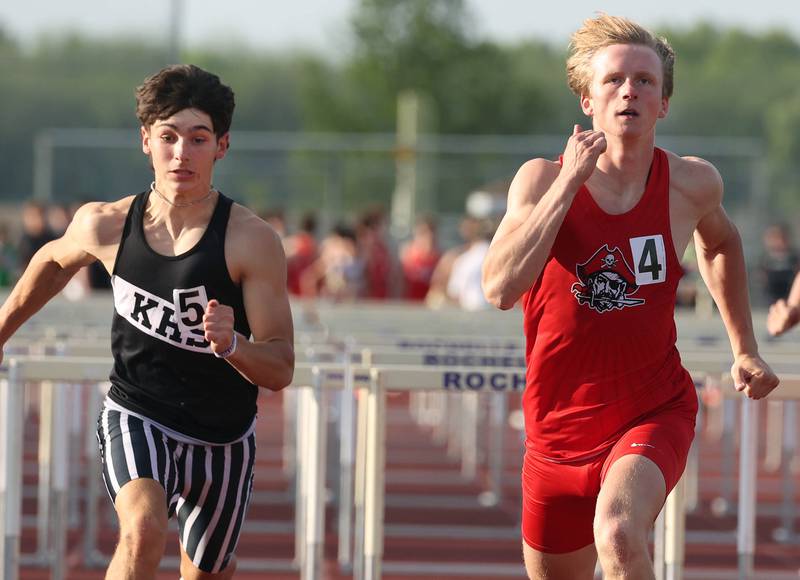 Ottawa’s Weston Averkamp crosses the finish line to win the 110 meter hurdles just ahead of Kaneland’s Luke Gadomski who got up for second Tuesday, May 13, 2025, during the Interstate 8 Conference boys track championships at Rochelle High School.