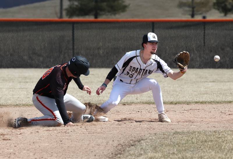 Sycamore's Trenton Meisch takes the throw as Byron’s Caden Considine just gets back to second during their game Wednesday, March 26, 2025, at DeKalb High School. Sycamore’s home field was damaged in last week’s storms so today’s game was played on DeKalb’s field.