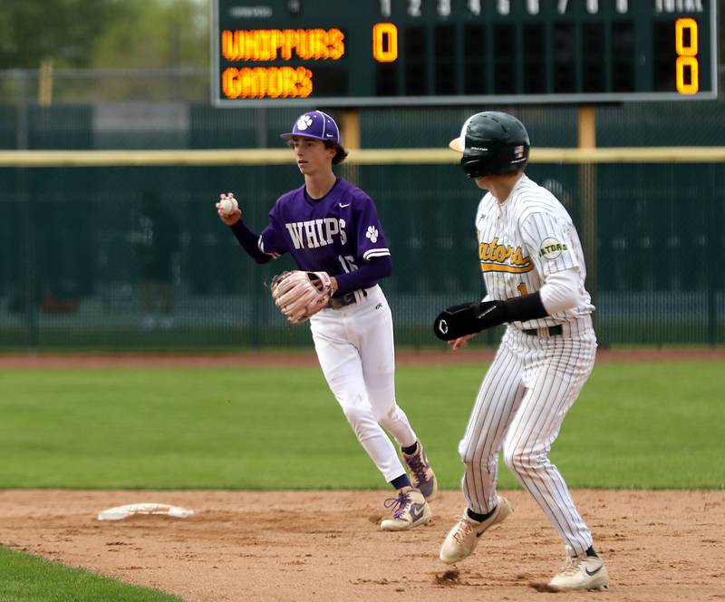 Hampshire's Gavin Weston tries to decide where to go with the baseball as Crystal Lake South's Anthony Amici tries to steal second base during a Fox Valley Conference baseball game on Monday, April 29, 2026, at Crystal Lake South High School.