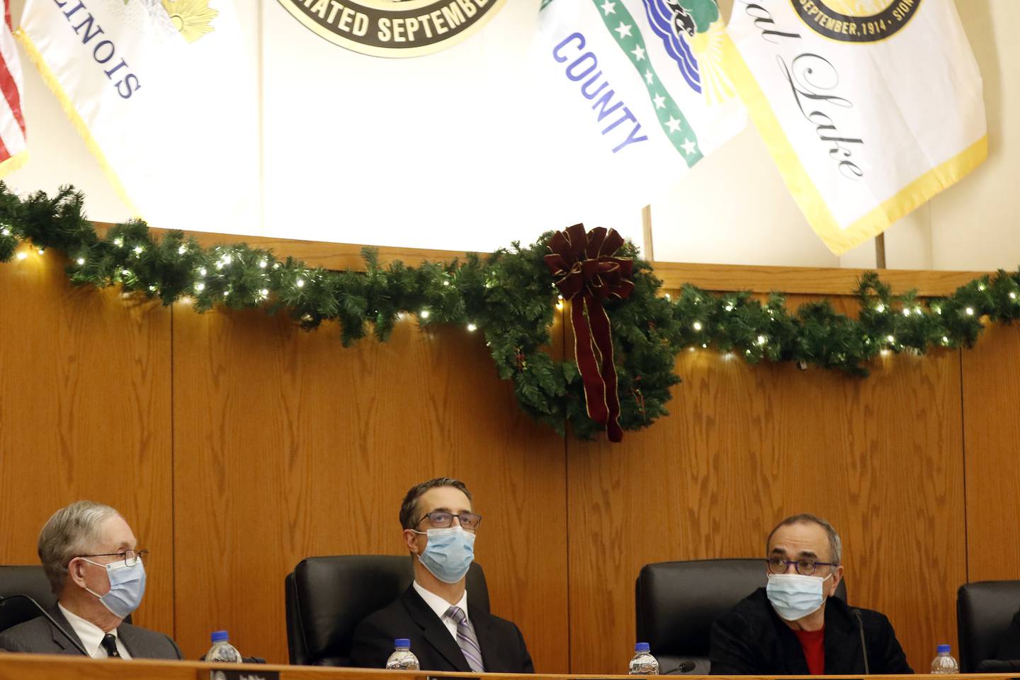 From left: City attorney John Cowlin, Deputy City Manager Eric Helms, and Mayor Haig Haleblian listen to presenters during a Crystal Lake City Council meeting on Tuesday, Dec. 21, 2021, in Crystal Lake. A vote was held on whether to allow a new Amazon warehouse in Crystal Lake.