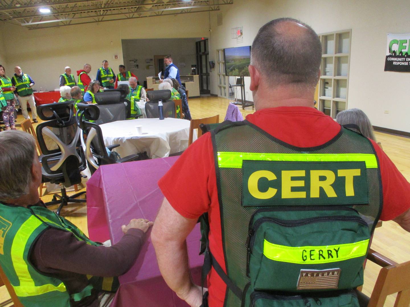 Gerry Brillion wears the vest issued to members of the Joliet Certified Emergency Response Team during a meeting of the group on Thursday. May 22, 2025