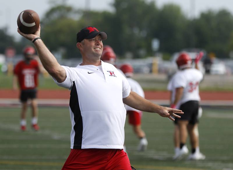 Huntley football Mike Naymola throws the football during a drill during the first day of football practice Monday, August 7, 2023, at the Huntley High School’s Red Raider Stadium.