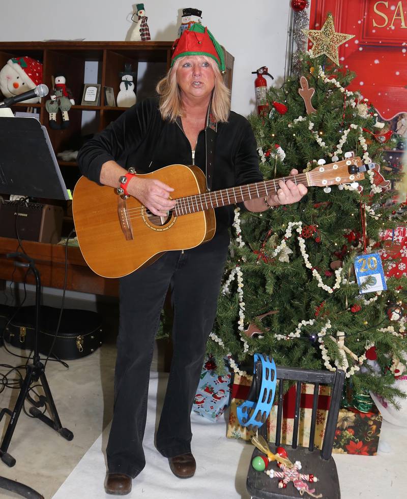 Trish Kinavy performs Christmas songs at the Kendall County Historical Society’s Annual Christmas at the Lyon Farm on Sunday, Dec. 8, 2024 in Yorkville.