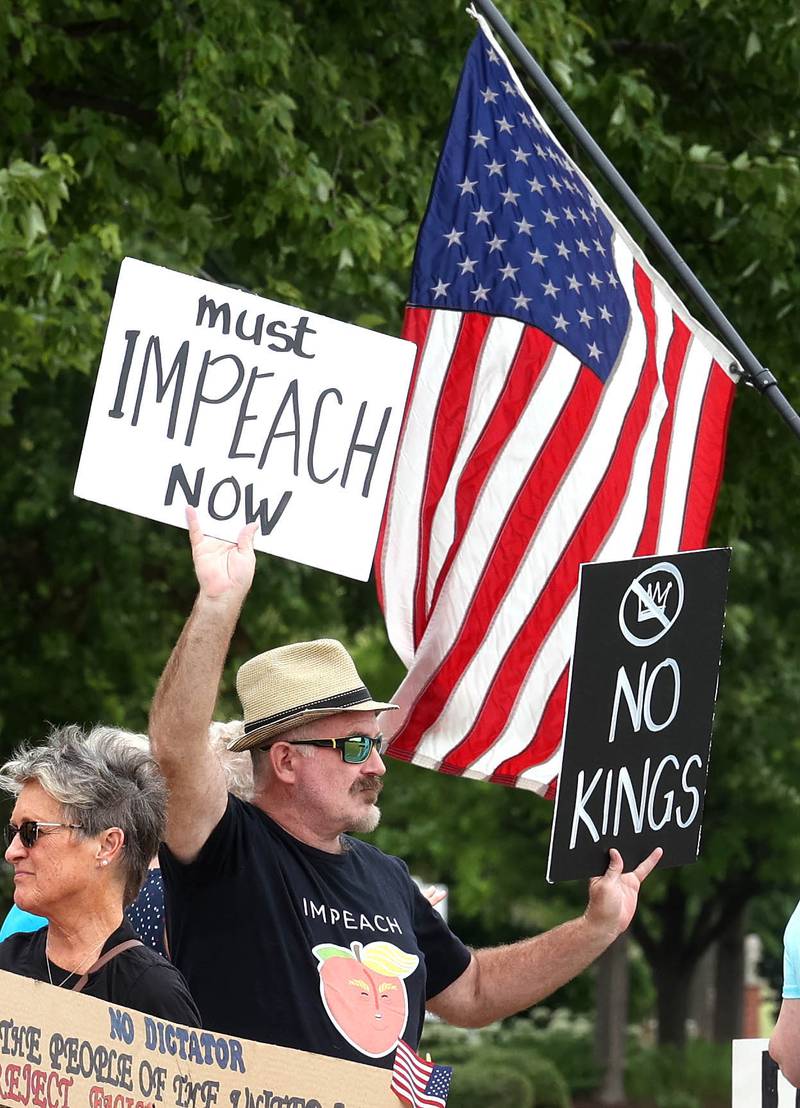 Protesters hold signs saying “Impeach,” and “No kings,” Saturday, July 4, 2025, at the corner of Main and State Streets in front of the DeKalb County Courthouse in Sycamore for a "No Kings" rally to voice their displeasure with President Donald Trump.
