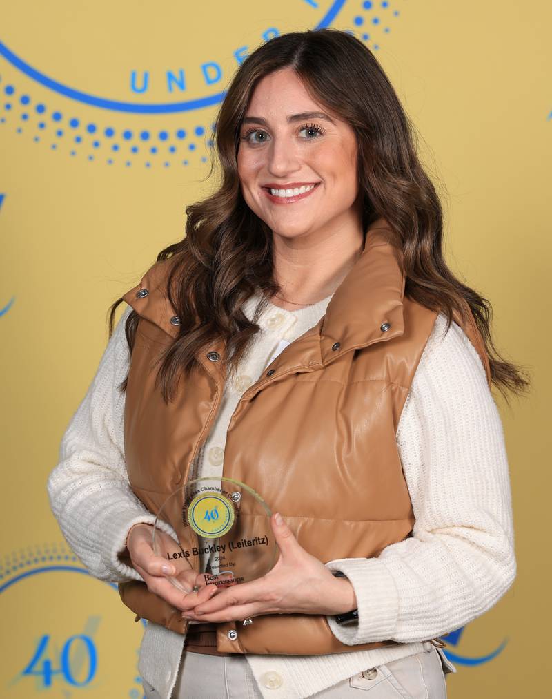 Lexis Buckley (Leiteritz) poses with her 40 Under Forty award during the Illinois Valley Chamber of Commerce Champions of Change Awards Night on Thursday, April 10, 2025 at the Westclox Event Center in Peru.