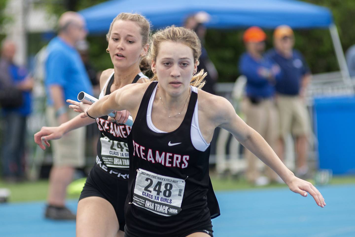 Fulton's Mikayla Gazo grabs the baton from Annaka Hackett in the 1A 4x2 finals during the IHSA girls state championships, Saturday, May 21, 2022 in Charleston.