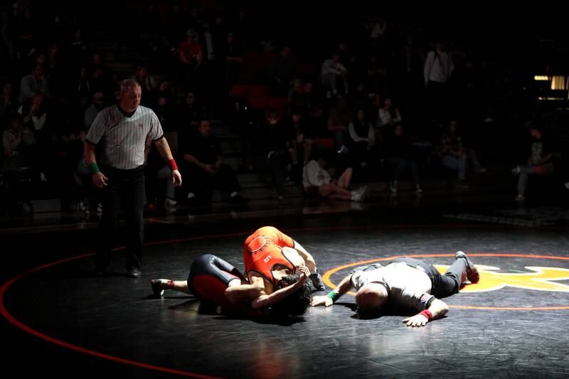 St. Charles East’s Payton Lee pins Batavia’s Ryan Adams in the 132-pound weight class during a dual meet in St. Charles on Thursday, Jan. 4, 2024.