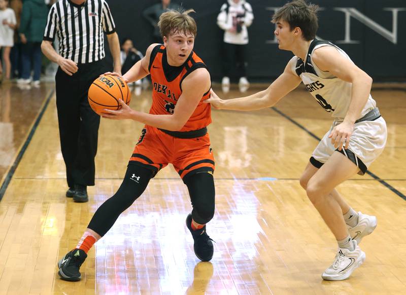 DeKalb's Sean Reynolds looks to drive by Kaneland's Preston Popovich during their game Tuesday, Jan. 28, 2025, at Kaneland High School in Maple Park.