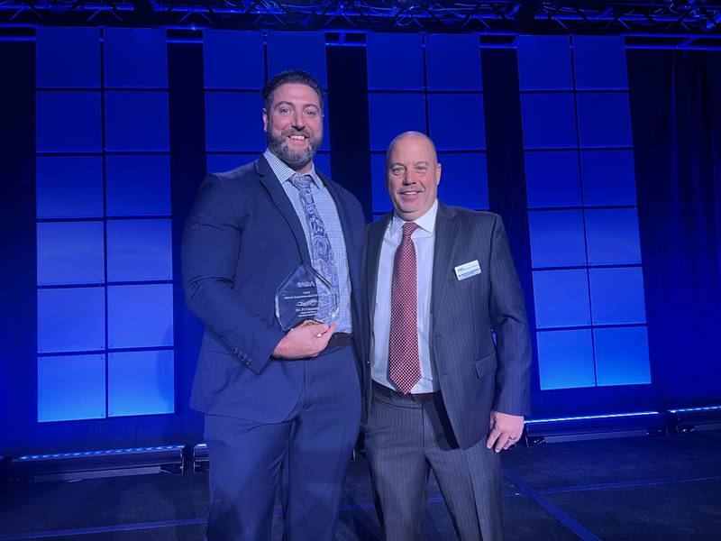 PJ Caposey, superintendent of Meridian Community Unit School District 223, left, appears on stage with Illinois Association of School Administrators President Kevin Blankenship. Caposey was named 2023 Superintendent of the Year.