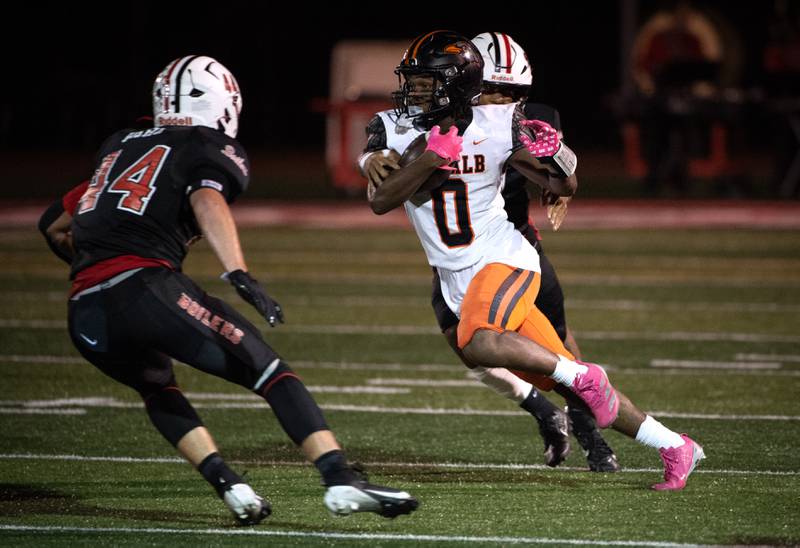 Dekalb's Brandon Williams Jr. carries the ball on a play as Bradley-Bourbonnais' Dereon Warren and Calvin Kohl, left, look to stop him in a game on Friday, October 10, 2025.