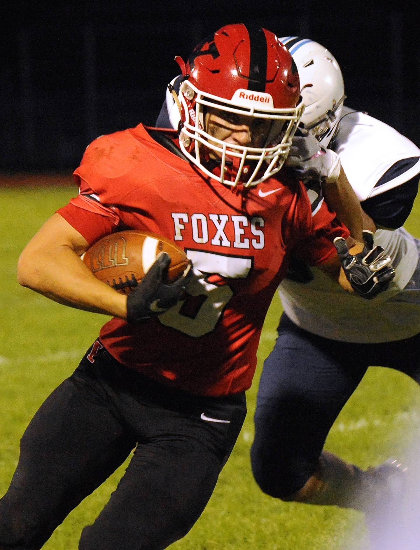 Yorkville defensive back Andrew Garton (5) advances an interception past Plainfield South wide receiver Aiden Sliwa (right) during a varsity football game at Yorkville High School on Friday.