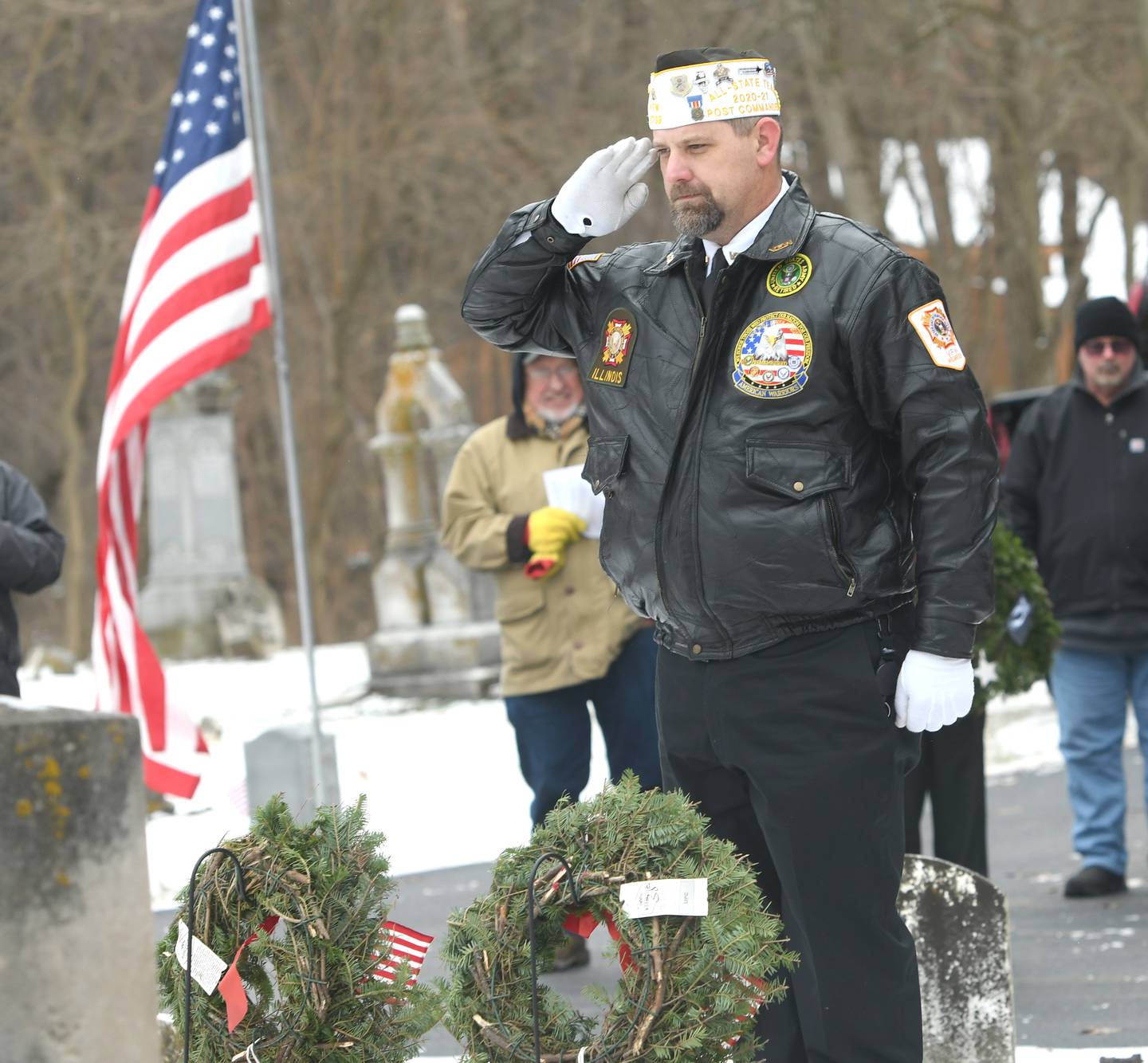 Jason Stoll of Oregon, an Army veteran, salutes after laying a wreath in honor of the Coast Guard, at Daysville Cemetery on Dec. 17 during the Wreaths Across America project. Wreaths were then placed on veterans' graves by other volunteers and veterans.