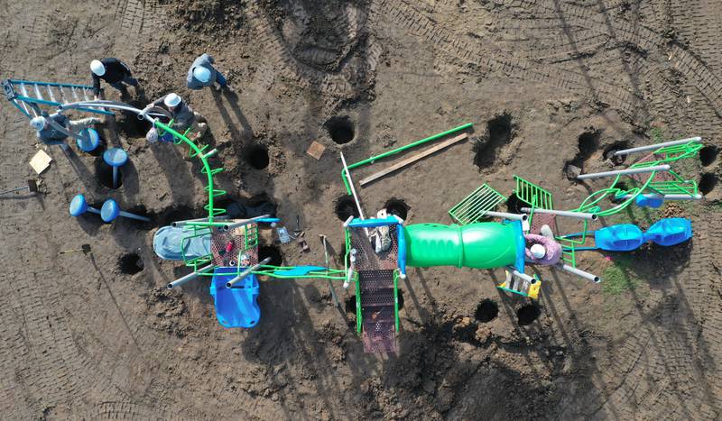 An aerial view of workers installing playground equipment at Sunset Park on Tuesday, Oct. 17, 2023 in Peru. Installation began this week on about $150,000 of upgraded playground equipment located on the south east part of Sunset Park near the intersection of 2nd and Henry Streets. The city received a grant of $43,000 for the new playground. Crews are hoping to have it completed by next week.