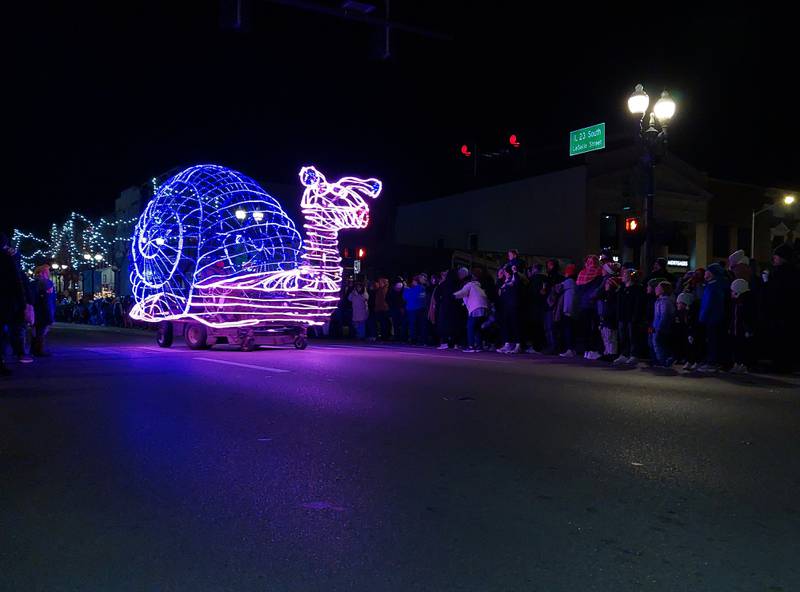 A lighted snail makes its way along the Festival of Lights parade route Friday, Nov. 24, 2023, in downtown Ottawa.