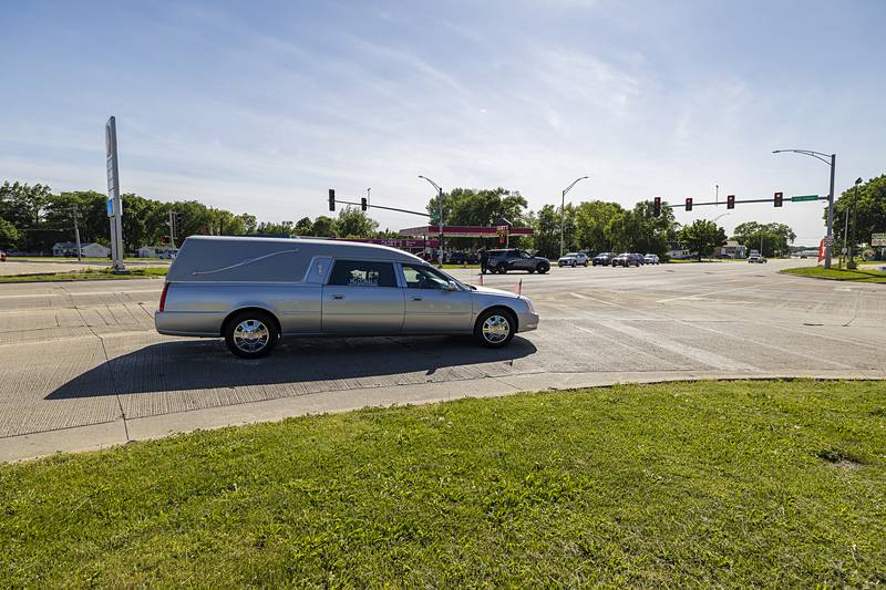 The hearse carrying the remains of U.S. Army Cpl. Richard Seloover makes its final turn Thursday, May 30, 2024 as it brings home the Korean War vet who was killed in 1950 at the age of 17.