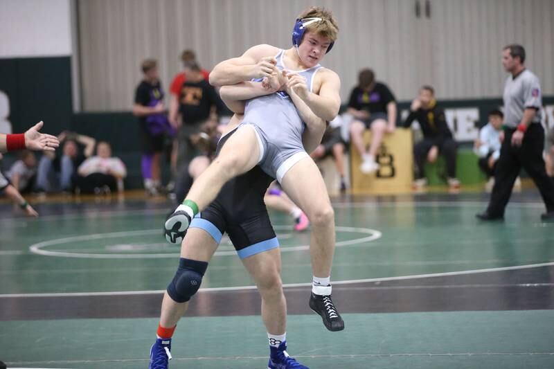 Marquette's Reily Leifheit lifts Princeton's Casey Etheridge in the 165 pound weight class during the Class 1A Regional meet on Saturday, Feb. 8, 2025 at St. Bede Academy.