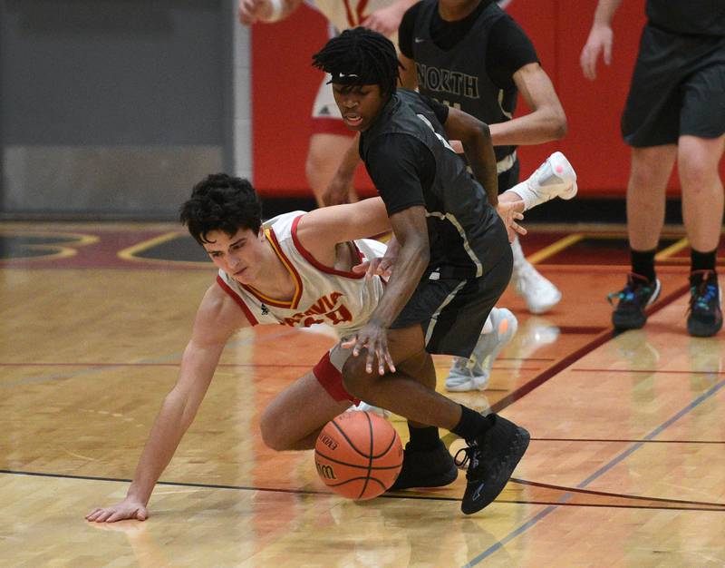 Batavia's C.J. Valente, left, and Glenbard North's Zion Reed chase a loose ball during Tuesday’s boys basketball game in Batavia.