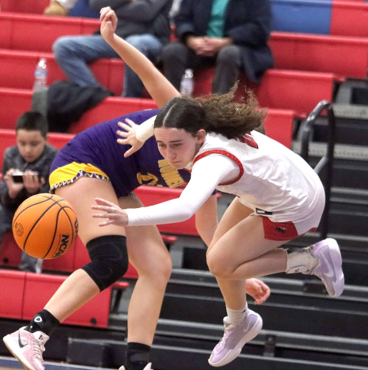 Huntley’s Luca Garlin gets tripped up against Hononegah in girls basketball at Dundee-Crown High School in Carpentersville on Tuesday, November 25, 2025.