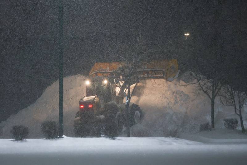 The mound of snow continues to grow as a snow removal company clears the parking lot of Menards before they open. Wednesday, Feb. 2, 2022 in Joliet.