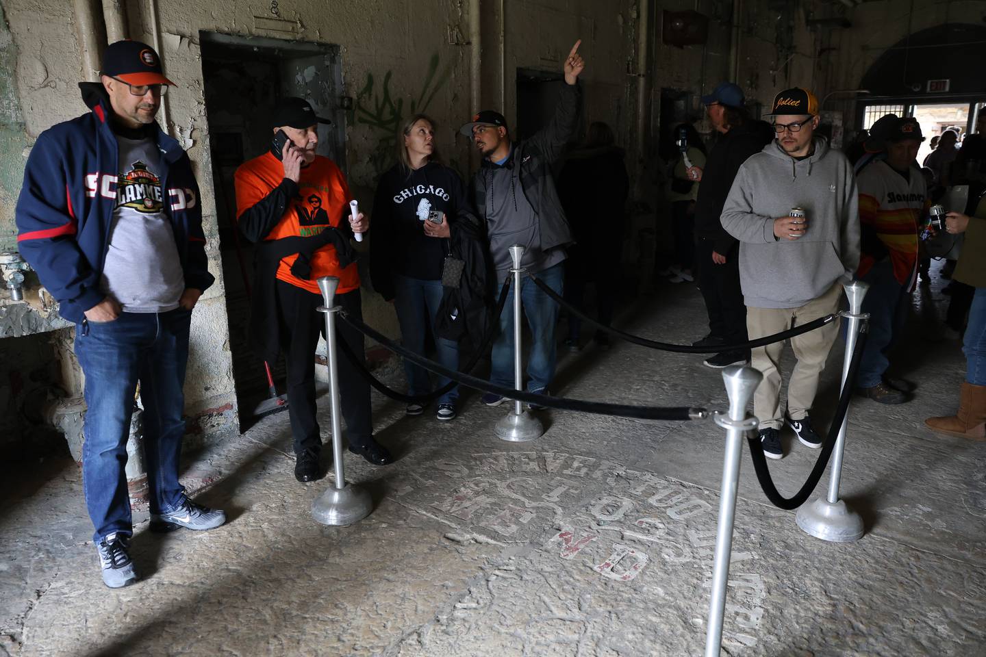 Fans check out the iconic “It’s Never Too Late to Mend” in the deathrow building before the Joliet Slammers preseason game at the Old Joliet Prison on Thursday, April 29, 2026 in Joliet.