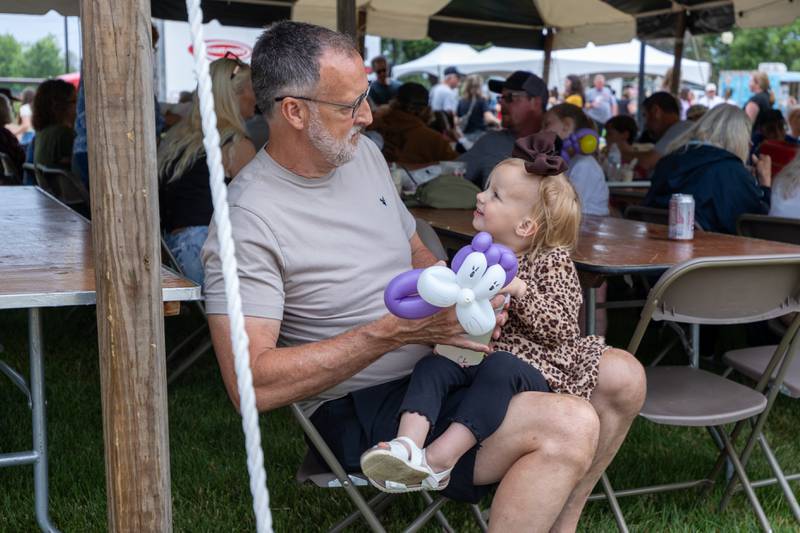 (left to right) Kevin Barnett holds Laiken Barnett at the annual Shrimp Fest on Saturday, June 7, 2025 at Rotary Park in Princeton.
