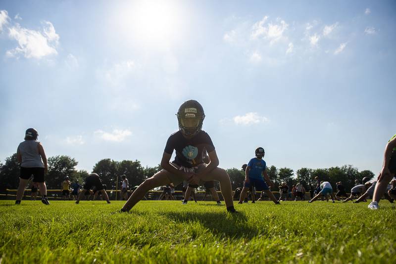 Rock Falls football camp members run through stretching drills Tuesday, July 19, 2022. Players of all ages attended the camp ahead of the upcoming season.