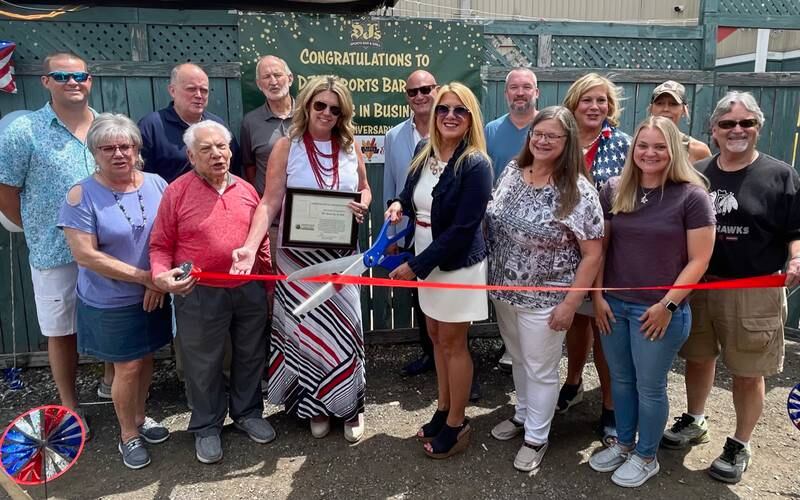 Pictured below with DJ’s Sports Bar owner Tracey Valerio Spotts include Village Manager Stephen
May, Mayor Ron Gunter, Westmont Chamber President Becky Rheintgen, 
friends, family, Westmont business community members.