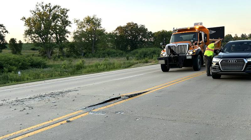A crew from the Illinois Department of Transportation (IDOT) repairs one of two pavement blowouts on Illinois Route 2 Tuesday evening, July 1, 2025. The state highway was closed between Oregon and Byron as crews patched the roadway. This blowout was just north of Silver Ridge Golf Course.