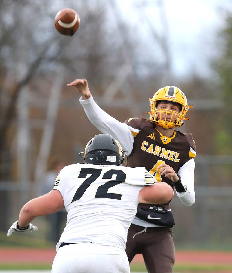 Carmel's Johnny Weber gets off a pass just ahead of the rush by Sycamore's Lincoln Cooley during their Class 5A second round playoff game Saturday, Nov. 5, 2022, at Carmel Catholic High School in Mundelein.