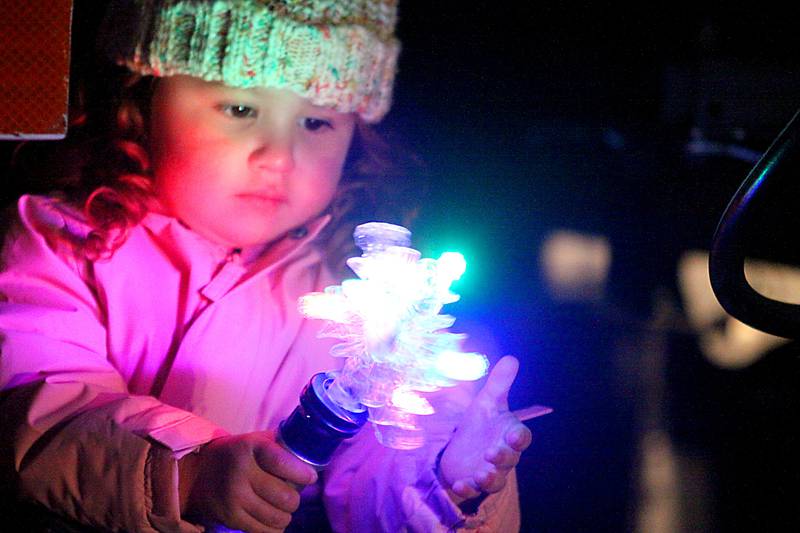 Brooklyn Casmer, 2, of Carpentersville plays with a lighted toy as she waits for Santa to arrive during A Very Merry Huntley on Saturday, Dec. 6, 2025.