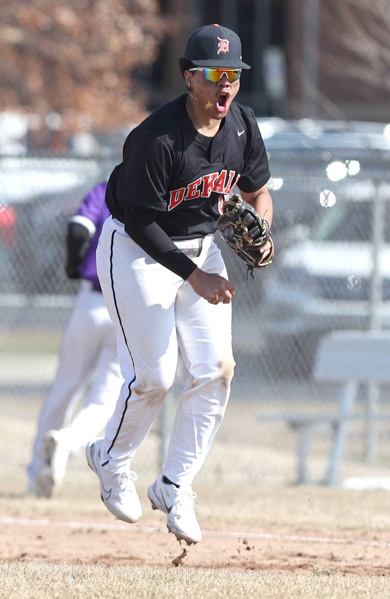 DeKalb’s Maddux Clarence reacts after picking a throw out of the dirt saving a run during their game against Dixon Tuesday, March 28, 2023, at DeKalb High School.