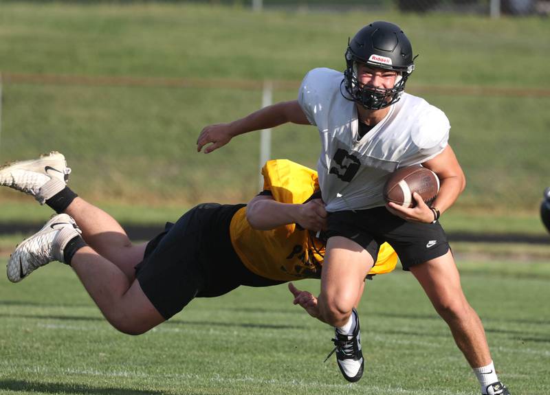 Sycamore’s Griffin Larson tries to shake off a Lena-Winslow defender Thursday, July 24, 2025, during a joint practice with Byron, Lena-Winslow and Sycamore at Sycamore High School.