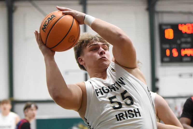 Bishop McNamara's Ian Irps grabs an offensive rebound during a home game against Lycee Francais de Chicago Wednesday, Feb. 18, 2026.