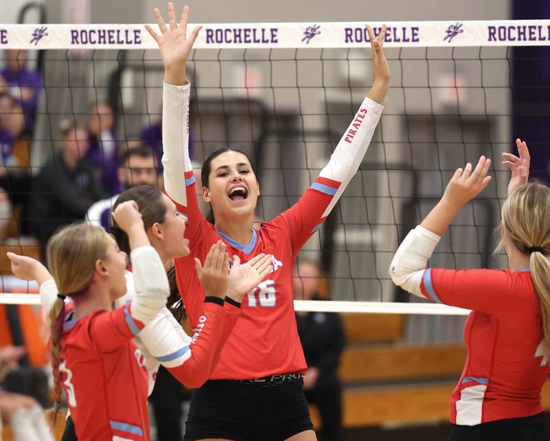 Ottawa players celebrate a point during their match against Dixon Tuesday, Oct. 28, 2025, during their Class 3A regional semifinal match at Rochelle High School.