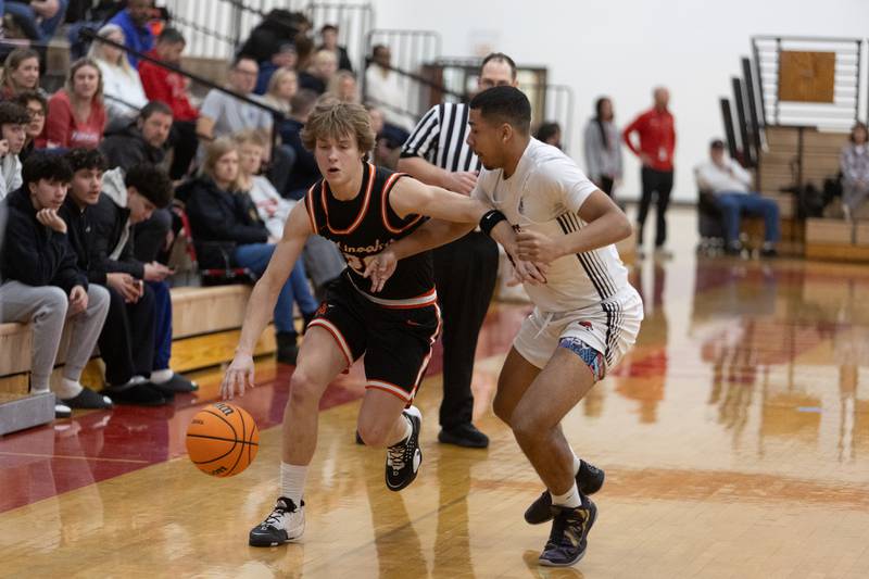 Minooka's Graham Lee is pressured by Yorkville's Vince Earl on Thursday, Jan.22,2026 in Yorkville.