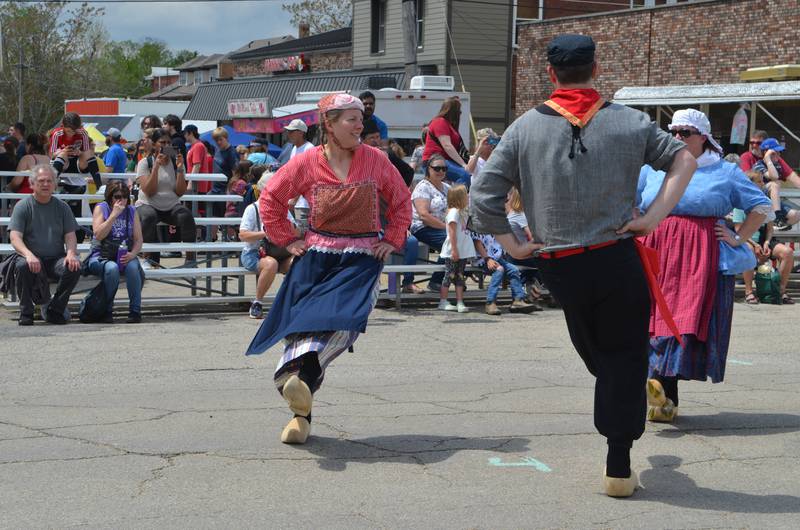 Kelly Preslan (left) kicks up her heels while klompen dancing with Kevin Preslan on Saturday, May 4, at Fulton's 50th annual Dutch Days celebration.