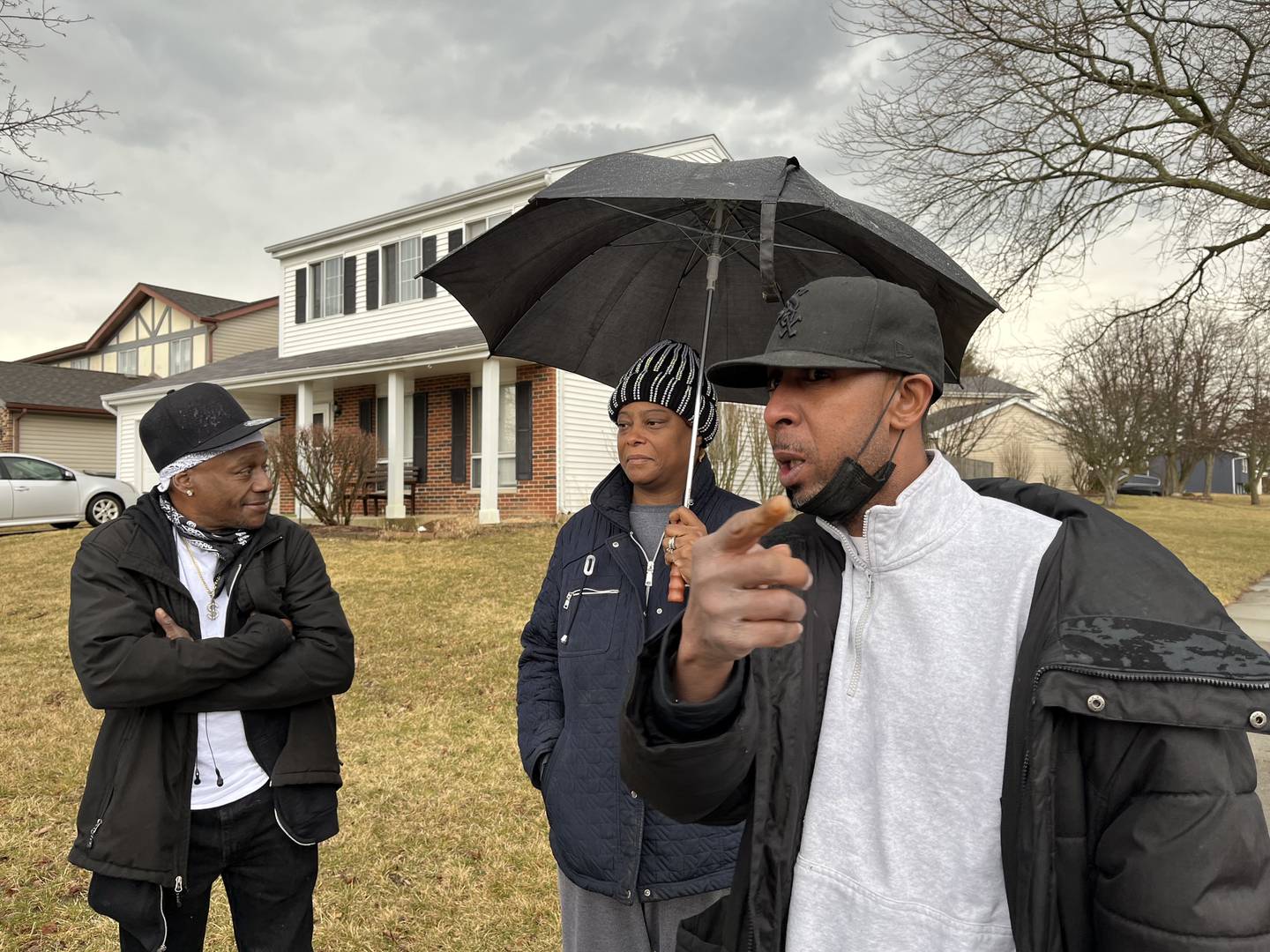 Hennessy Parnell (left), Melinda Taylor and her husband, Anthony Taylor, talk with reporters about the deadly shooting in the 100 block of Lee Lane in Bolingbrook on Monday.